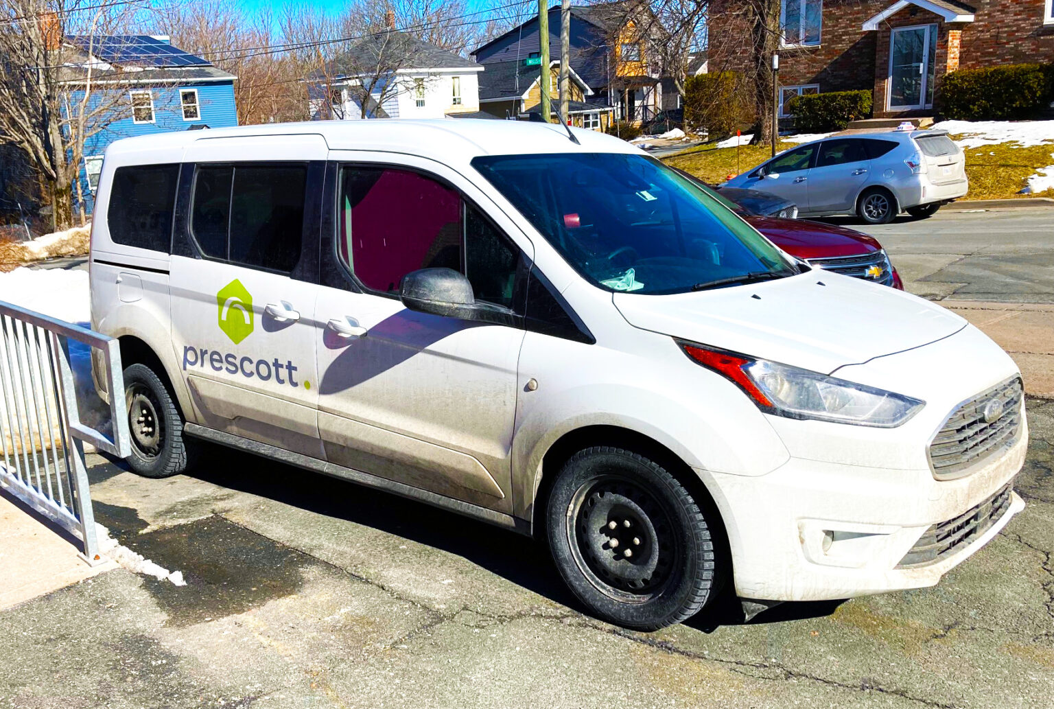 white van with prescott logo on the passenger side